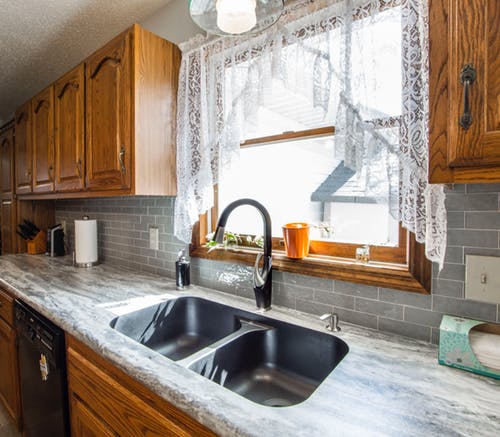 Standard Kitchen Sink with granite countertops and cabinetry