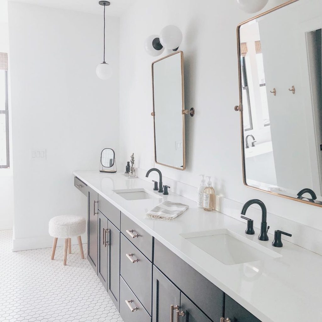 farmhouse bathroom with white hexagon floor and black and gold accents Bathroom Lighting Ideas