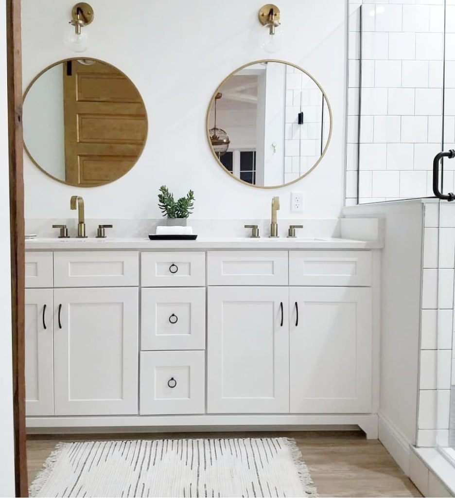 bathroom with white vanity and gold accents Bathroom Lighting Ideas