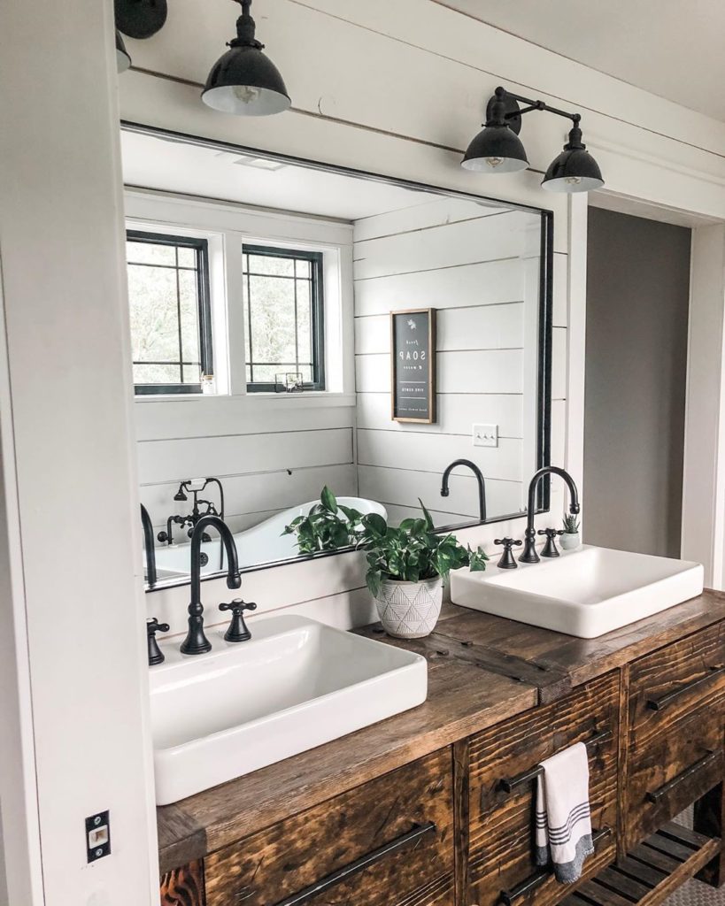 shiplap walls with rustic vanity in bathroom and black accents faucet Bathroom Lighting Ideas