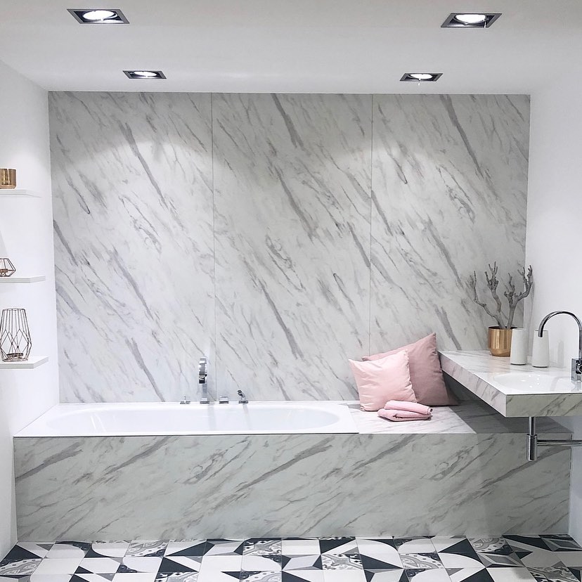 high end gray bathroom with marble and busy tie floor