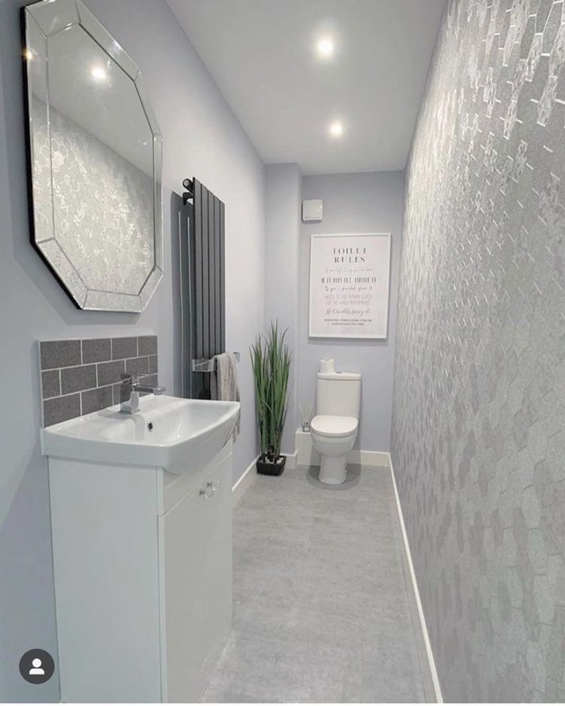 bathroom with gray shiny wall paper and gray subway tile