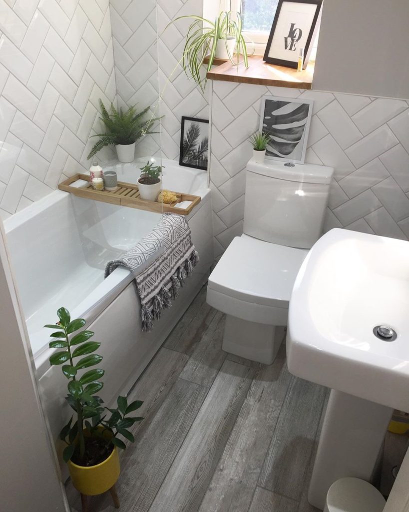 gray bathroom with gray hardwood floors and subway tile