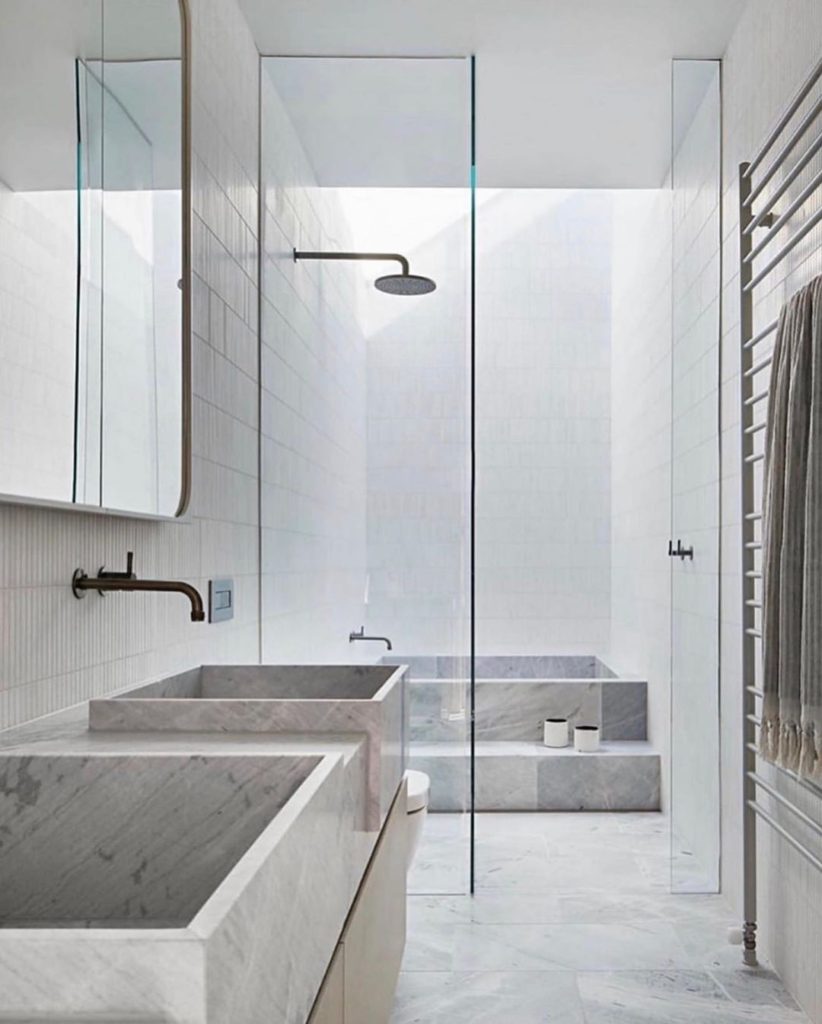 gray bathroom with natural stone faucet basins and natural stone floors