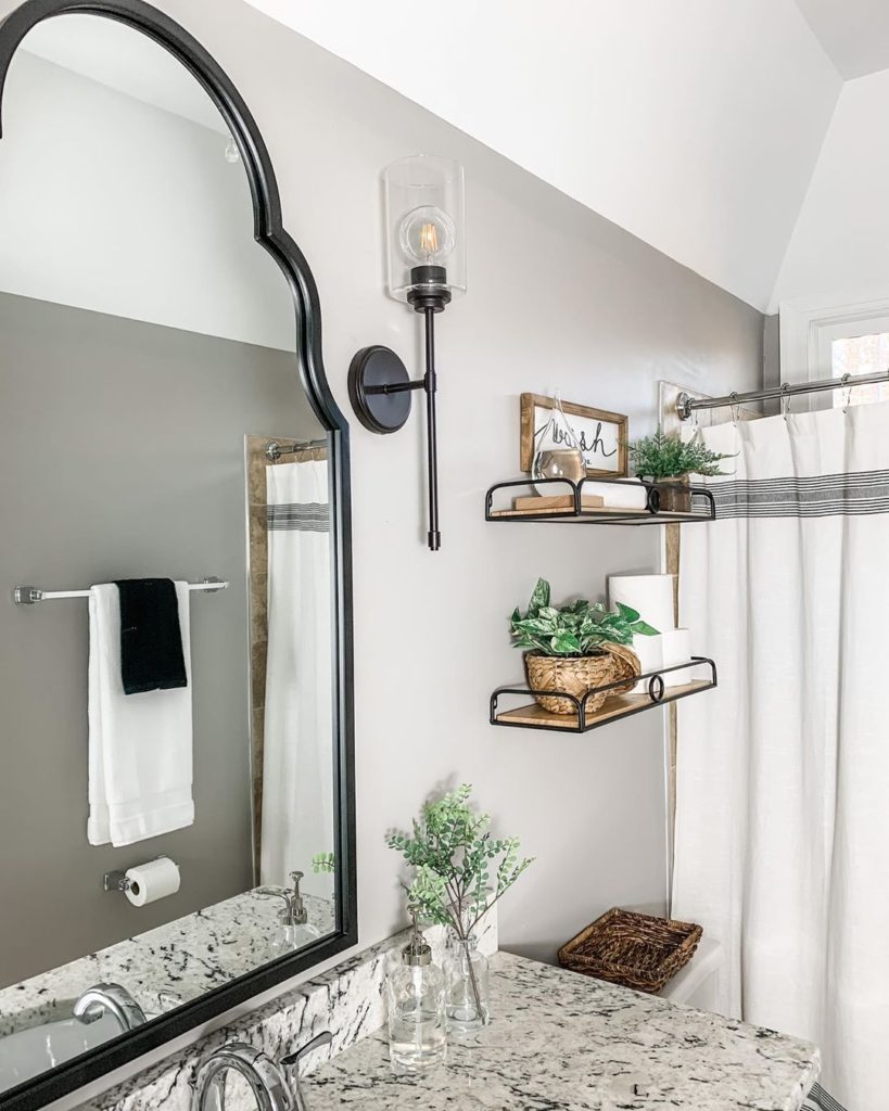 gray bathroom with granite countertop and rustic shelves