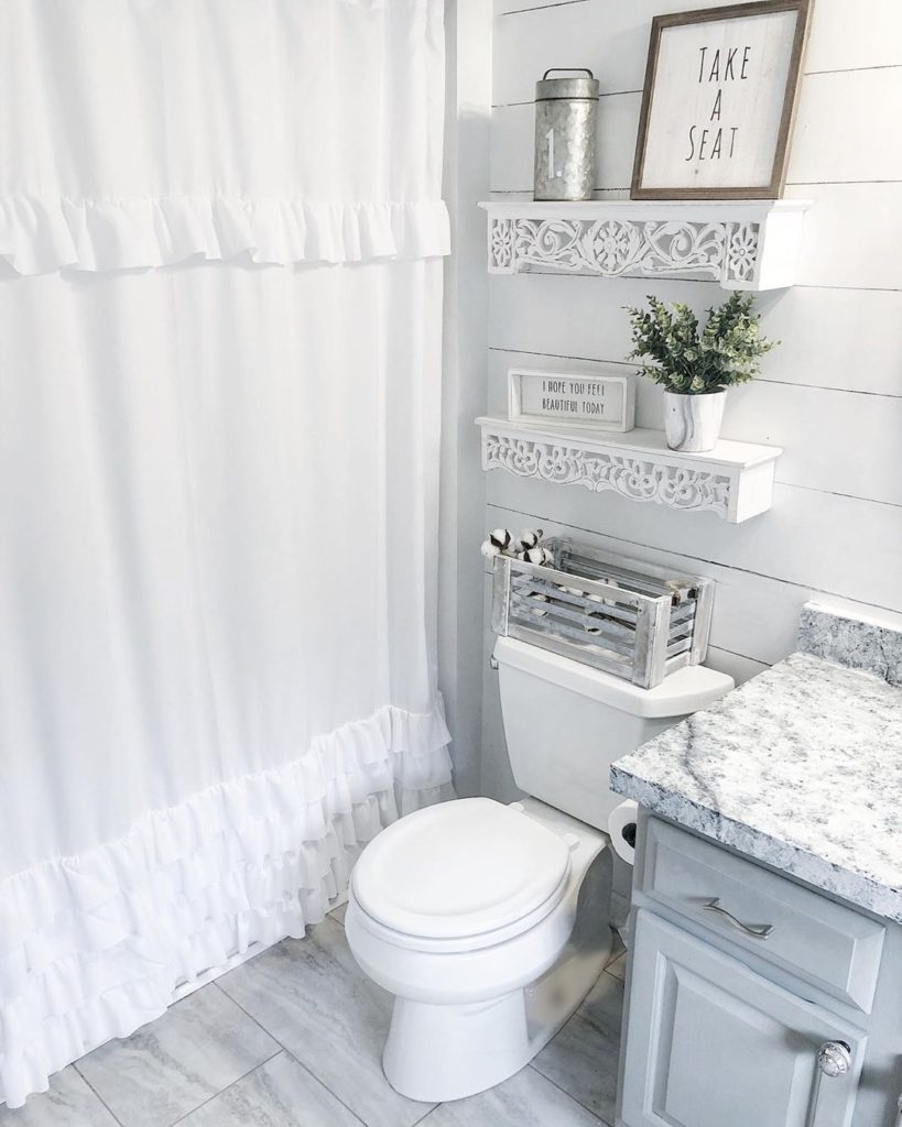 guest bathroom in gray with marble floors and shiplap walls