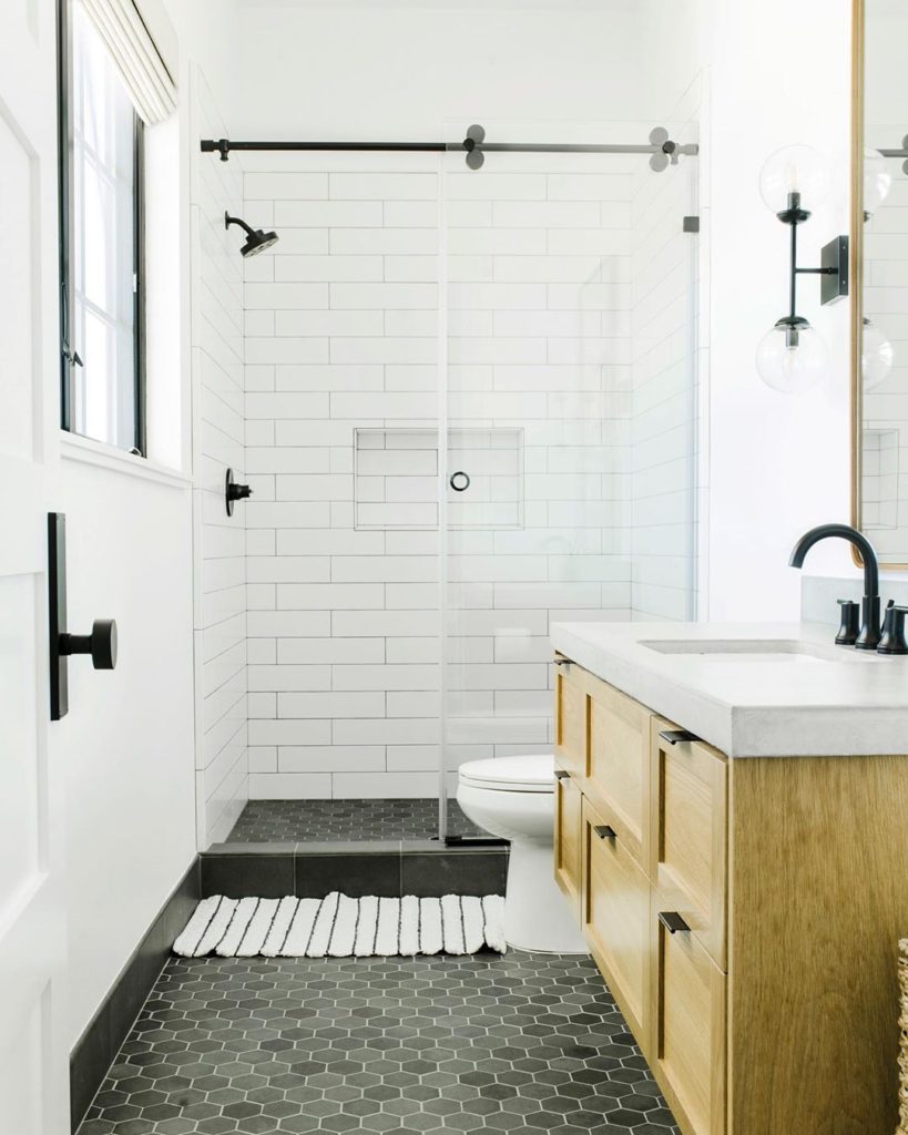 guest bathroom with charcoal gray floor and subway tile