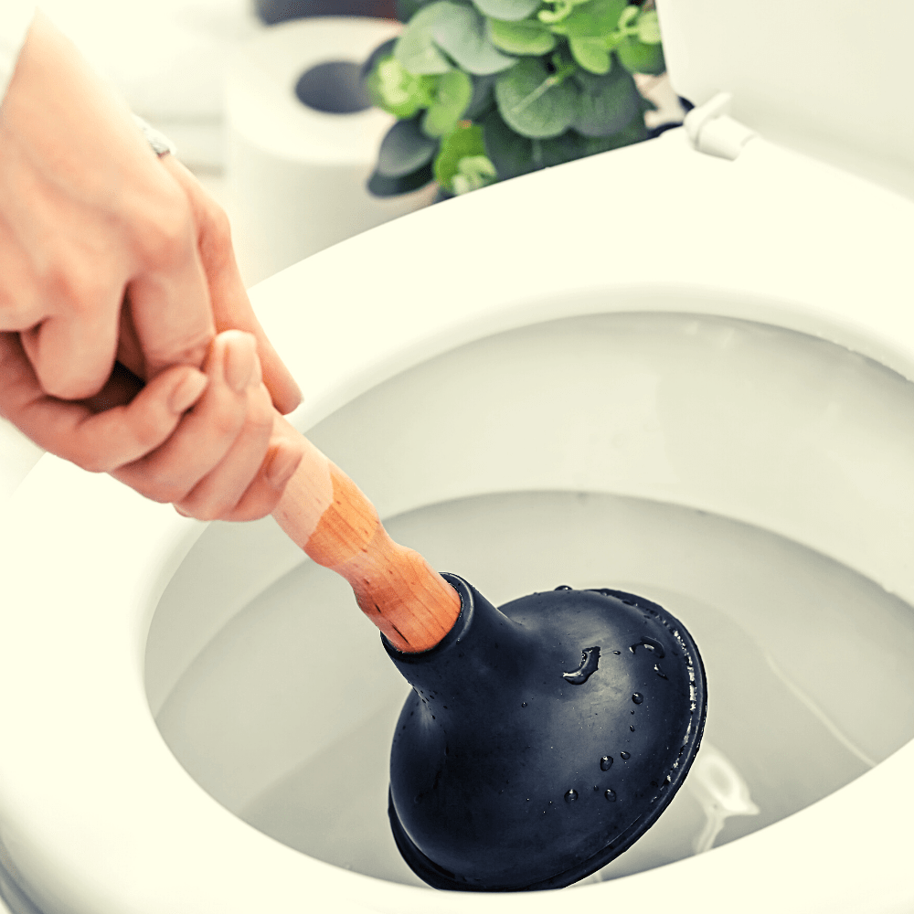 Plunger being used to drain clog