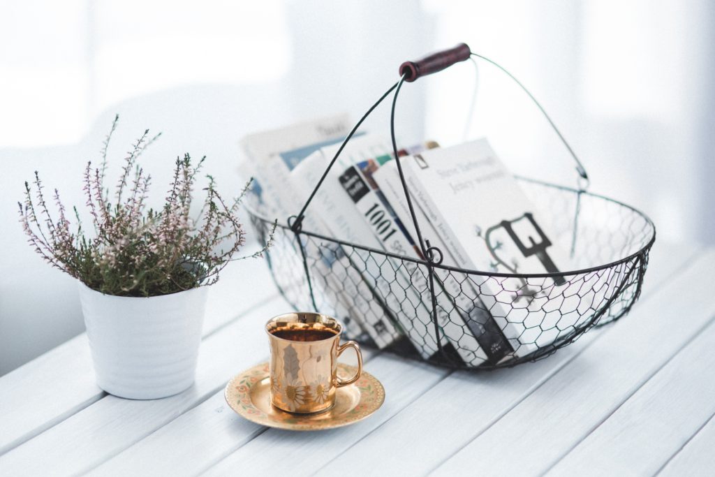 Coffee table with wire basket and gold teacup