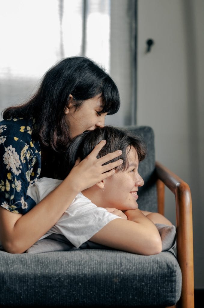 Couple laying down on a couch