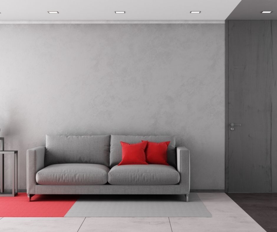 red rug under gray couch