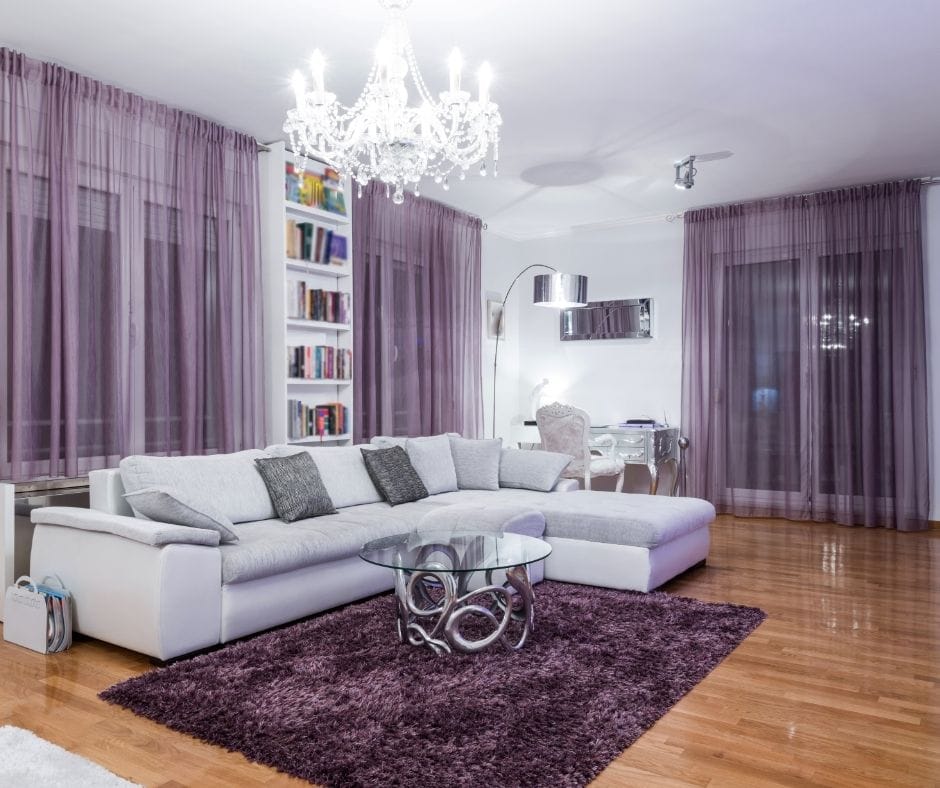 purple rug under gray sofa