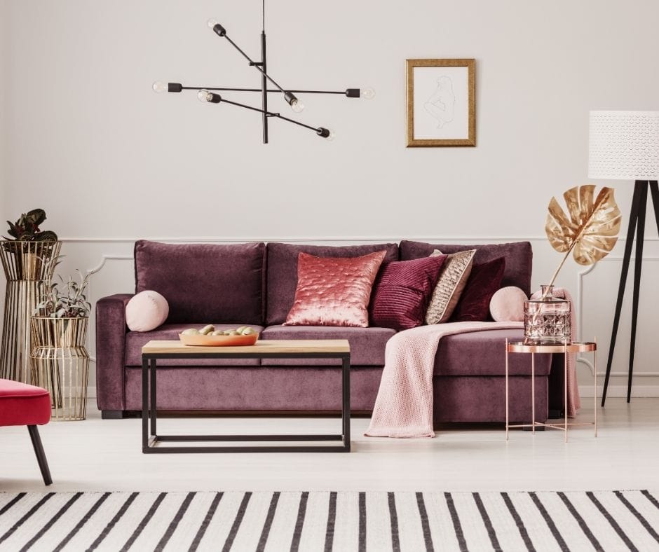 black and white rug under red couch