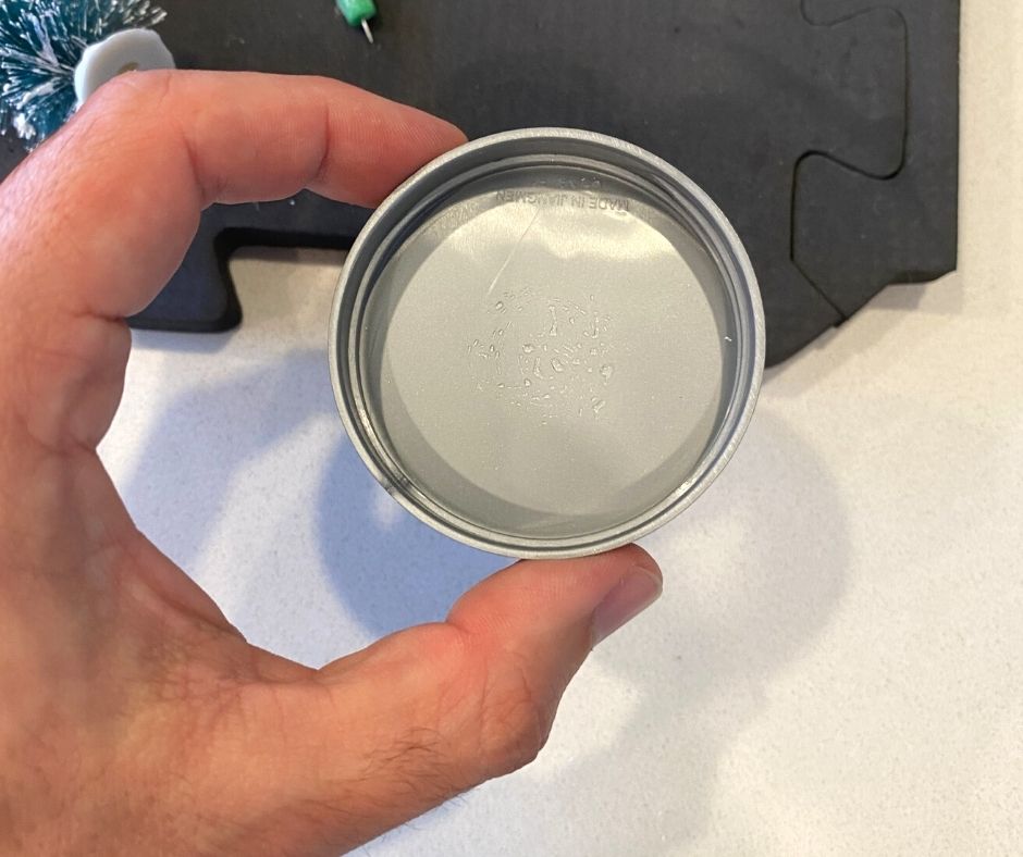 small plastic mason jar lid with crazy glue on it