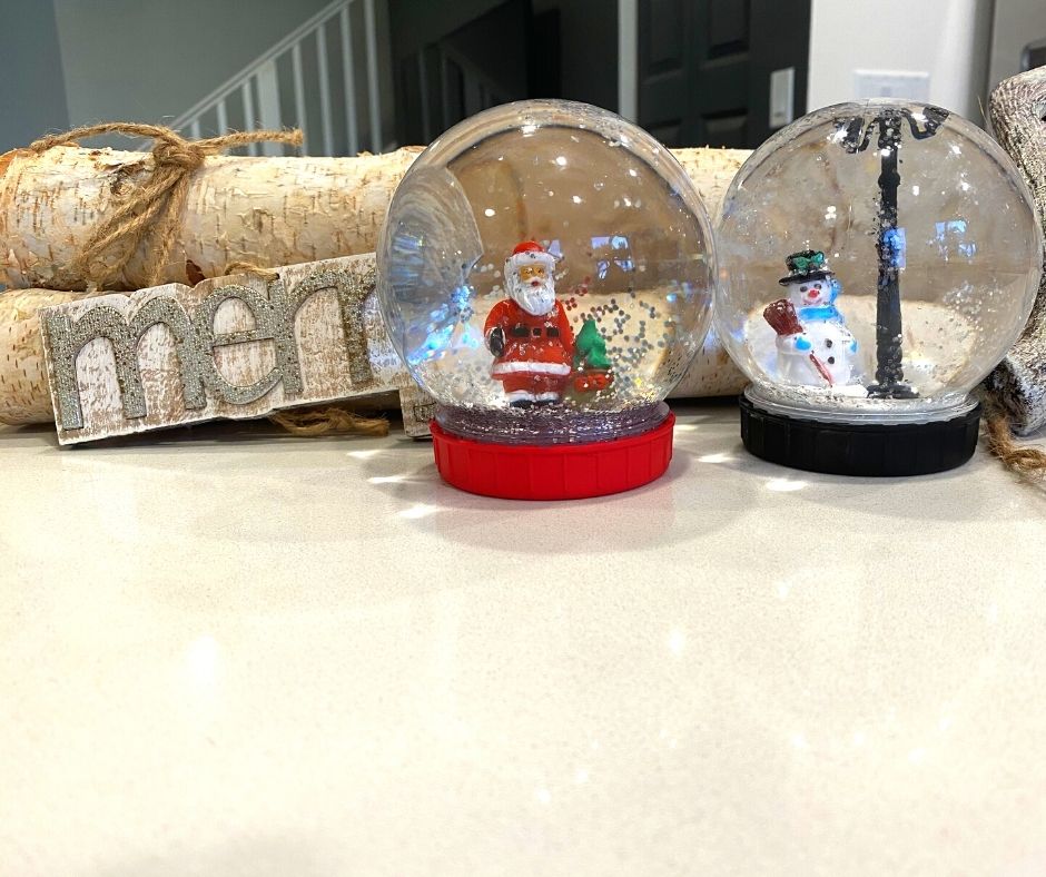 diy snow globes on display red and black with snowman and santa