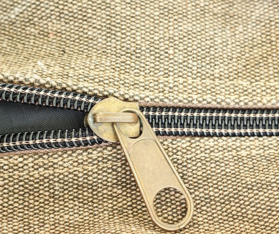 sofa cushion zipper being unziped to expose cushion