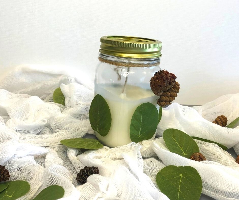 decorative euclyptus leaf and pine cone mason jar candle