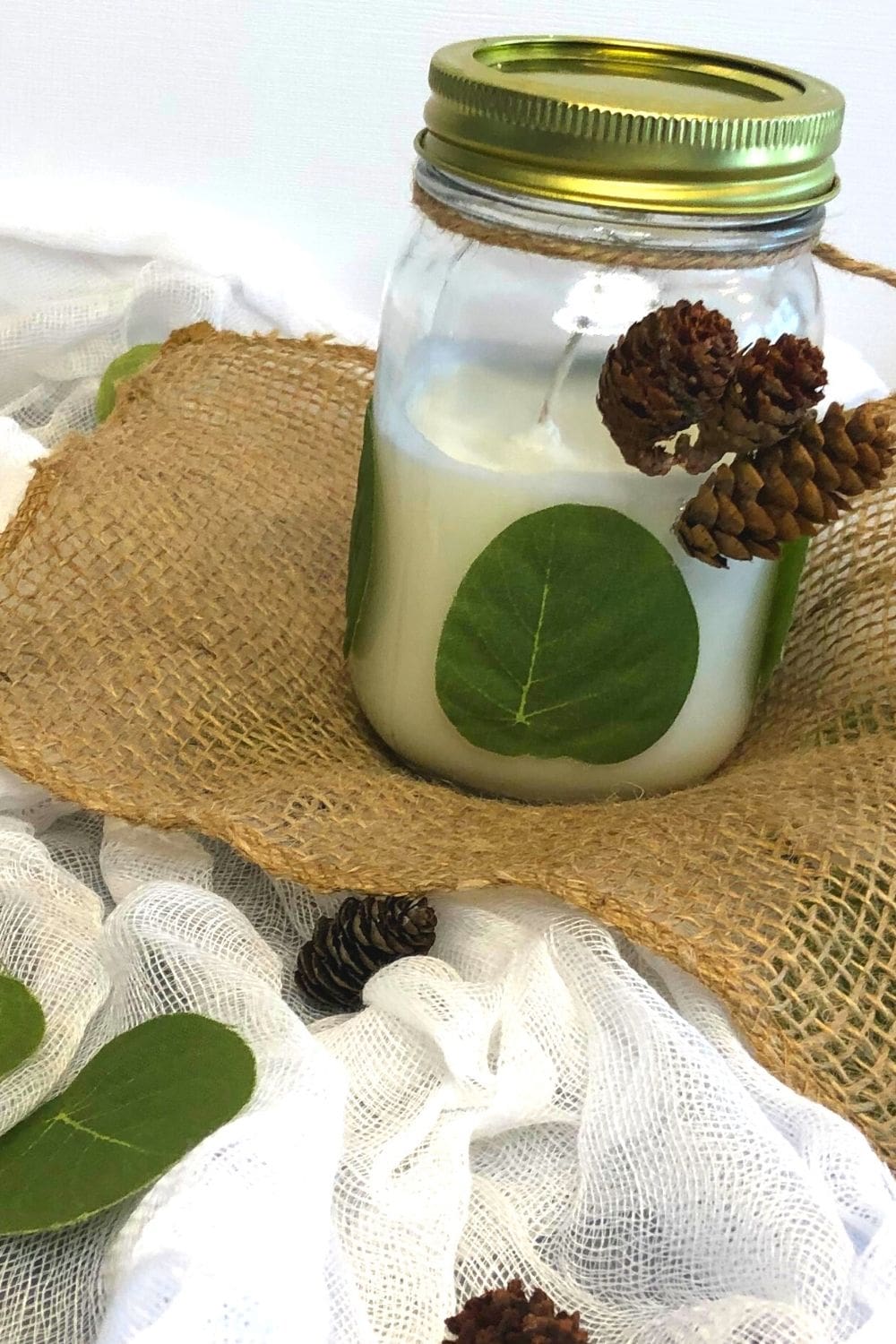 decorative candle in mason jar on top of burlap