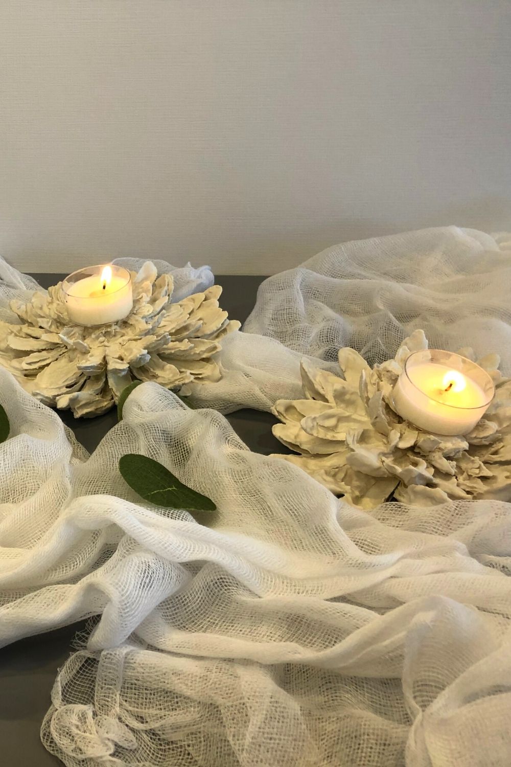 Plaster of paris flowers with tea lights on them