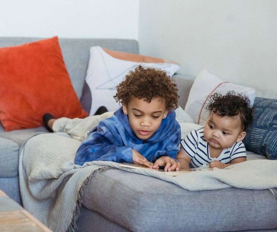 Children laying down on a couch