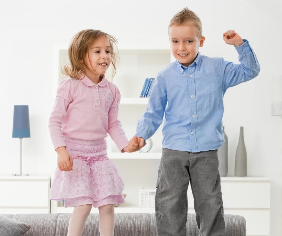 Children jumping on couch