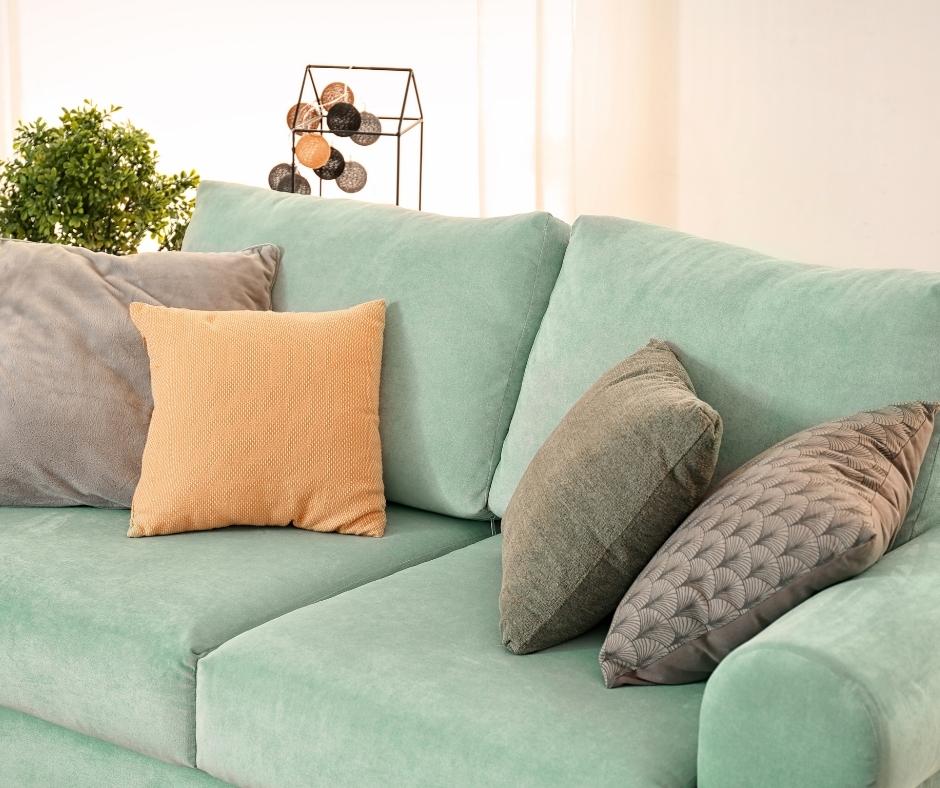 orange and grey cushions sitting on a sectional