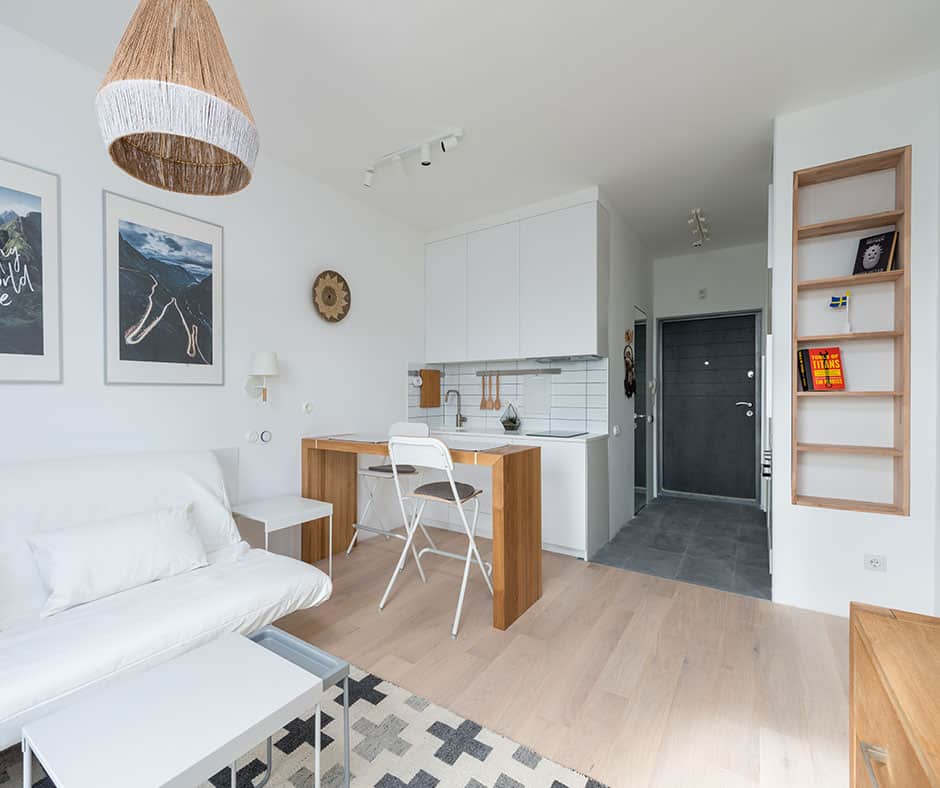 A well coordinated kitchen and living room with neutral colors