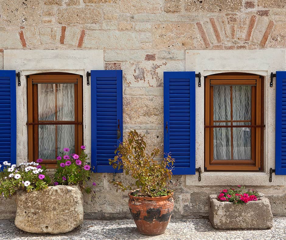 A view of two windows with curtains clearly visible