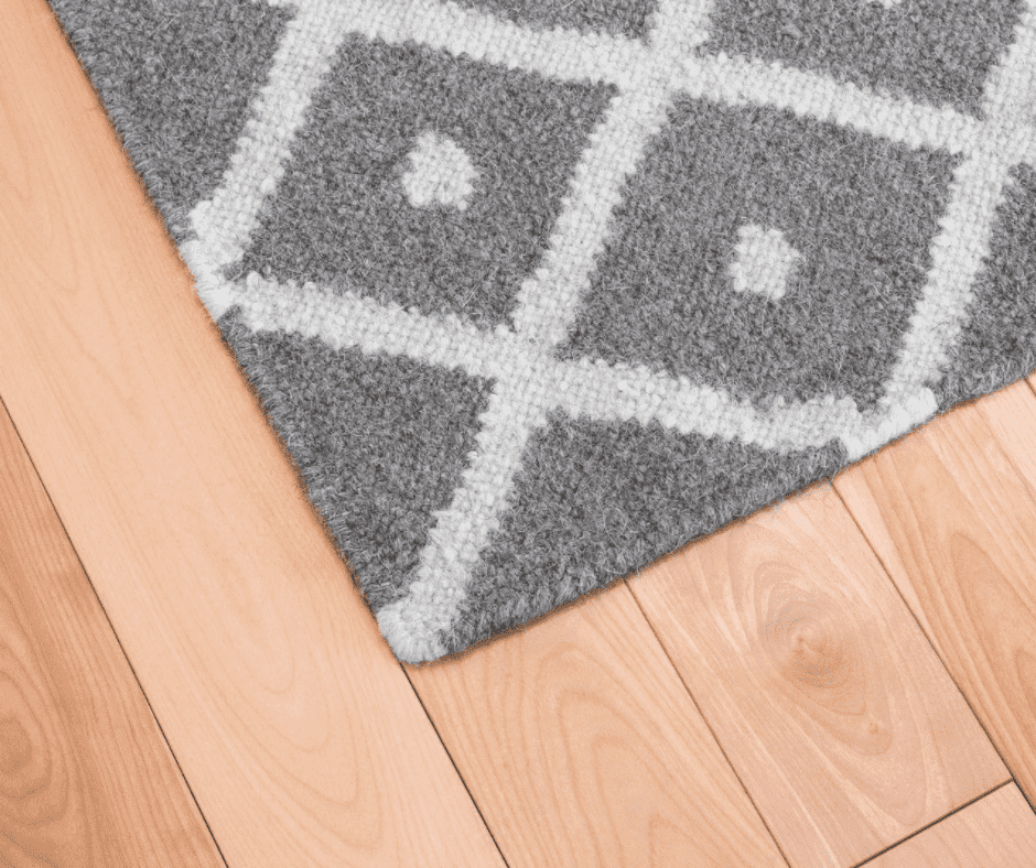 Gray pattern-designed rug on vinyl plank flooring