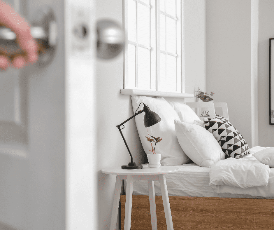 Blurred image of white bedroom door with image of bed and nightstand