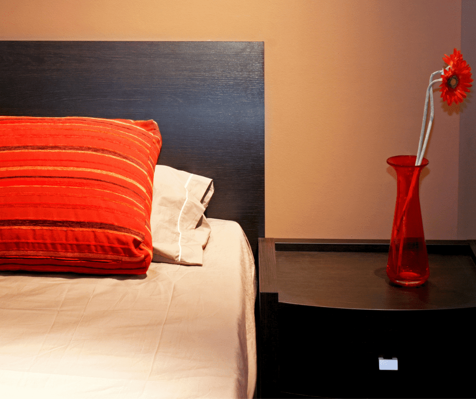 Brown bed with red decor