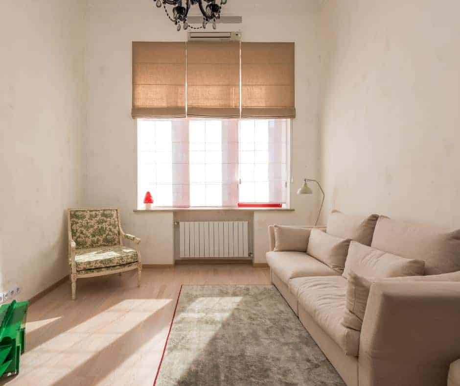 a gray rug laying down on the ground in a nice room