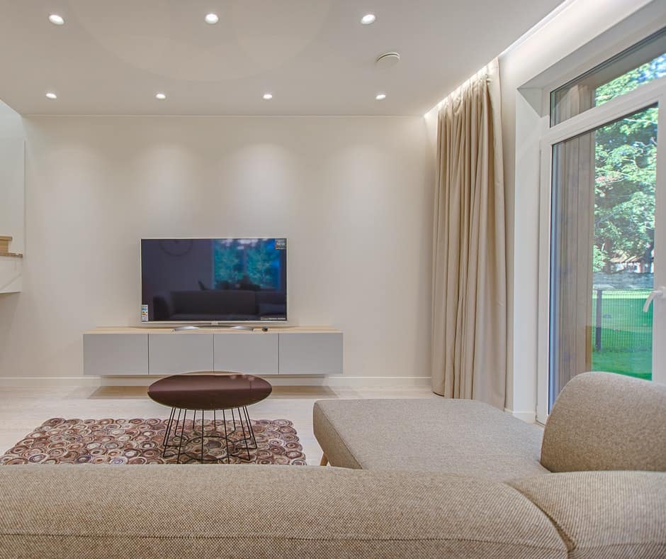 Living room with seven ceiling lights, a tv and minimalist decor