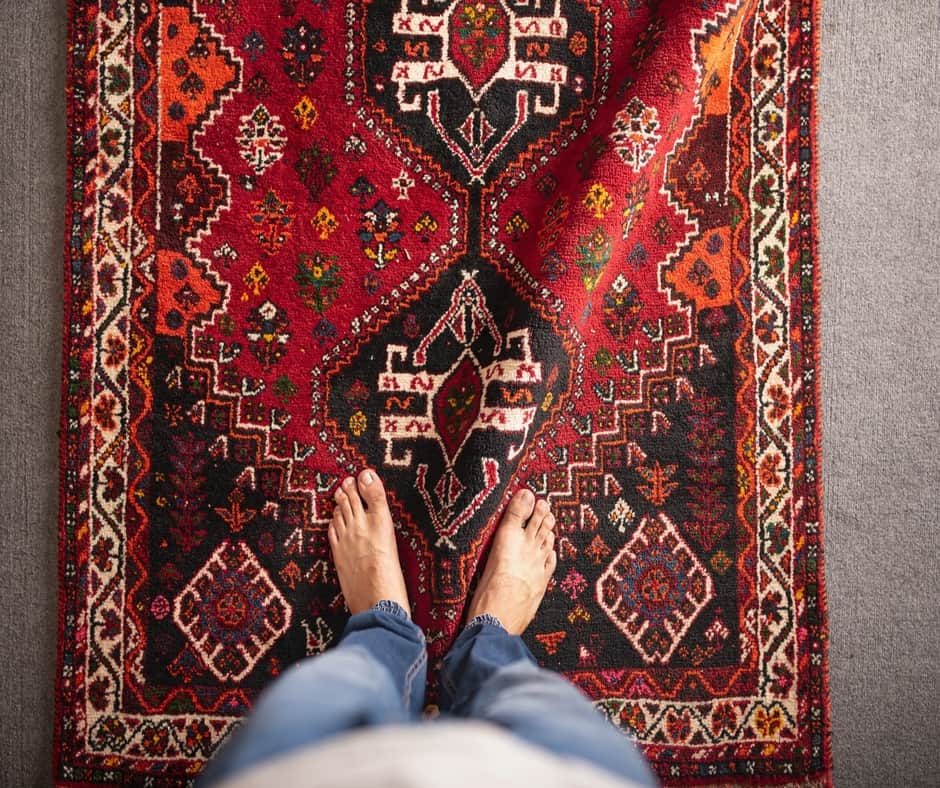 A man standing on a beautiful rug