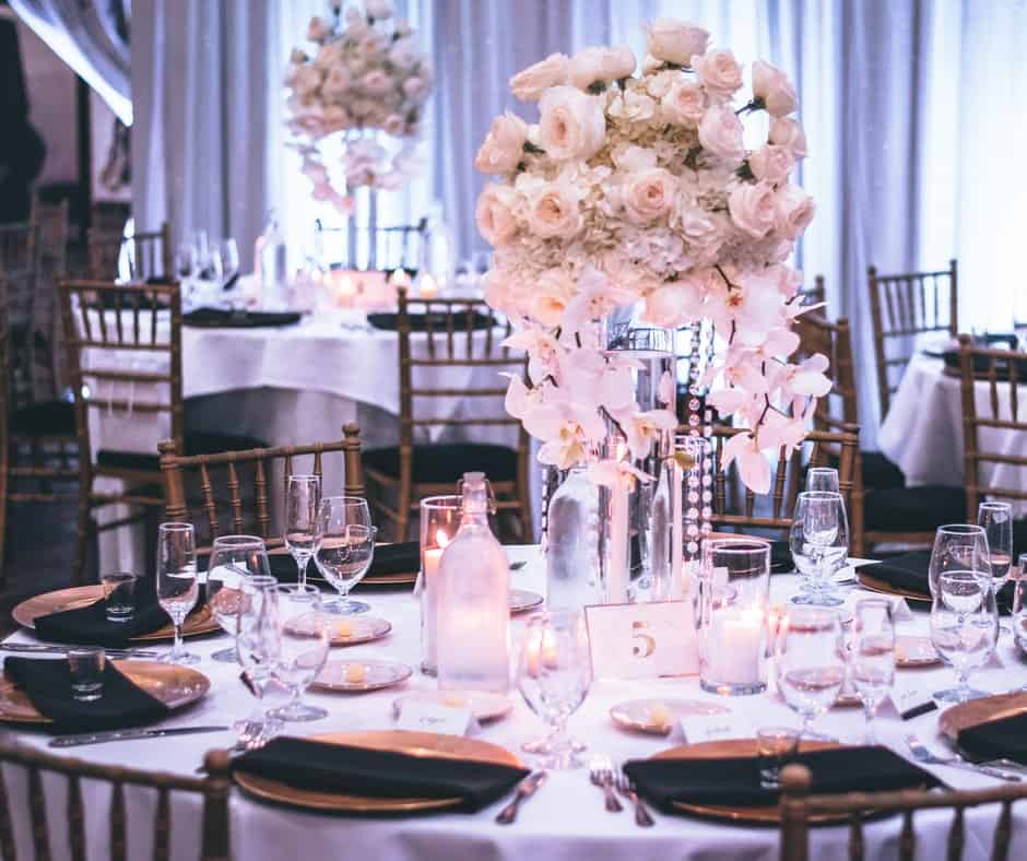 Skirted tables with cutlery and flower decorations