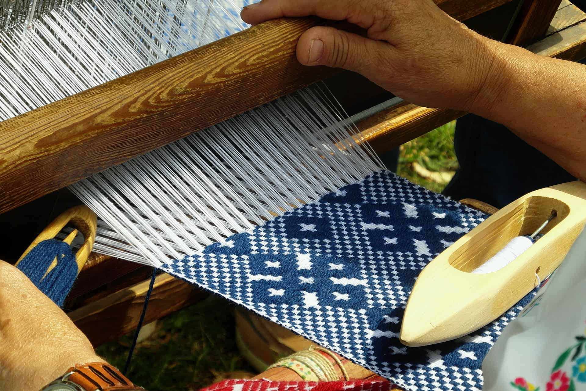 Weaving with a loom in progress using wool 