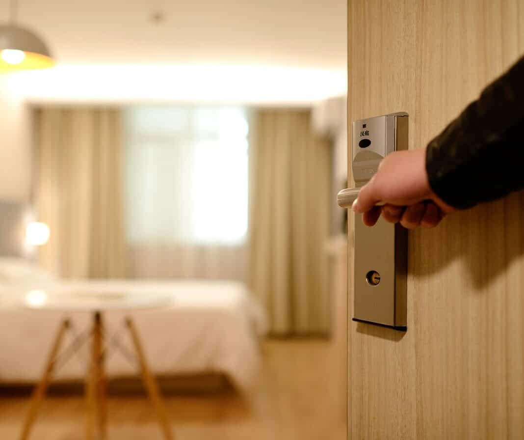 Door half-closed revealing spacious bedroom