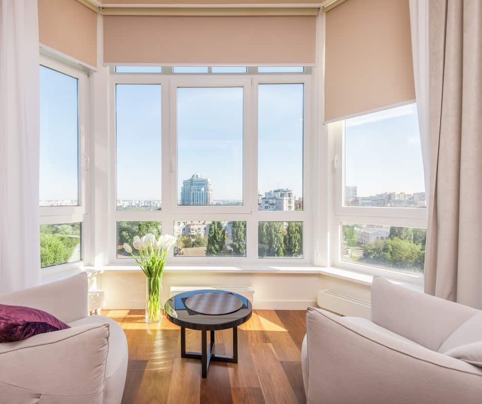 Living room area with curtains and blinds