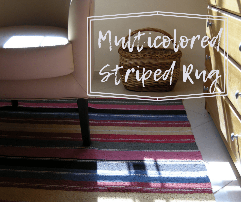 Multicolored striped rug with beige couch