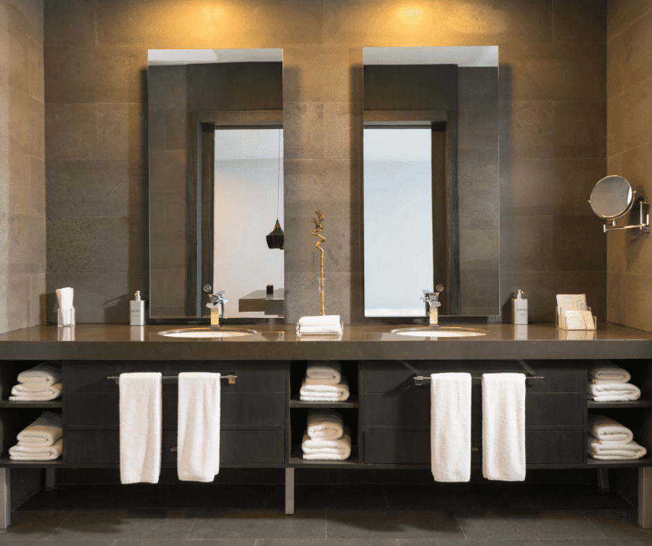 A bathroom with 2 sinks and mirrors