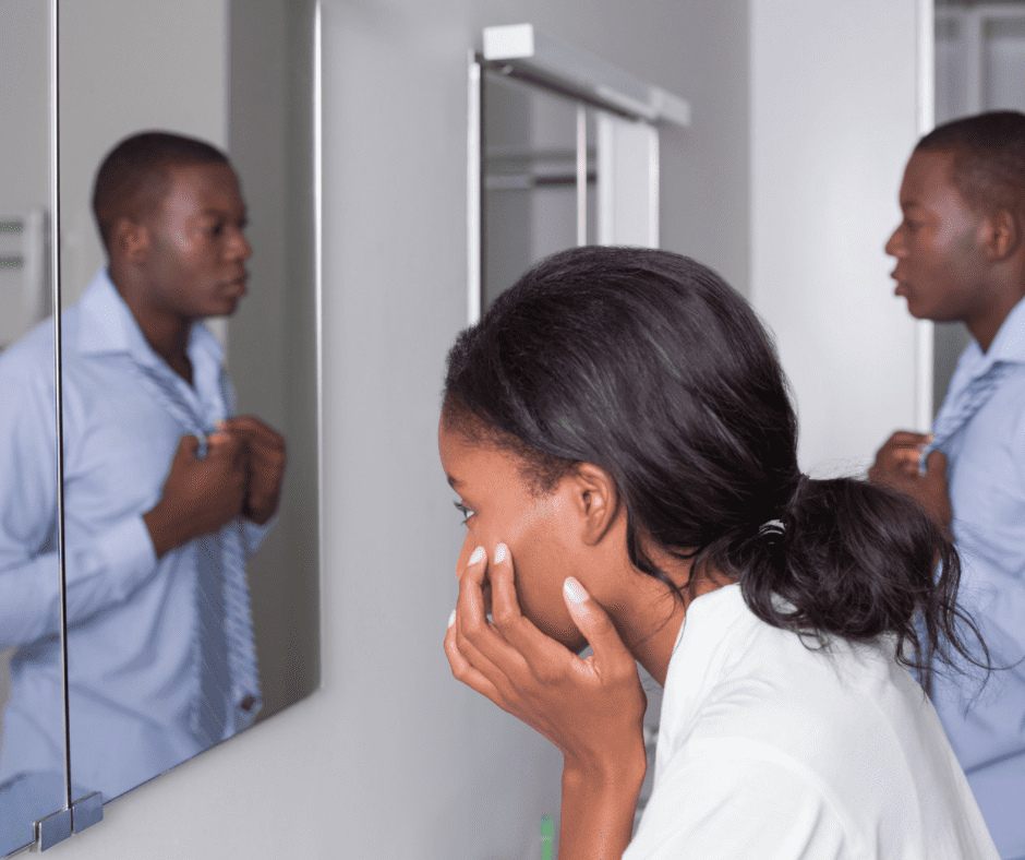 A man and a woman looking at the hollywood bathroom mirror