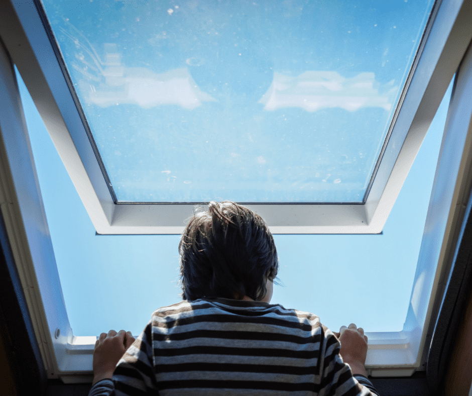 A boy peeking through an awning window