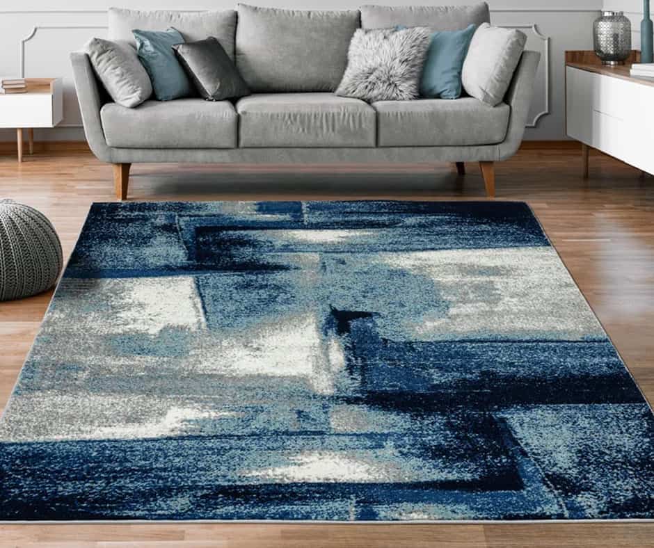 Living room with a steel blue, gray, and white rug