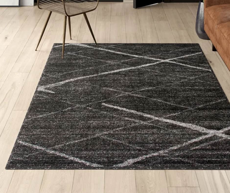 Living room with a dark charcoal geometric rug