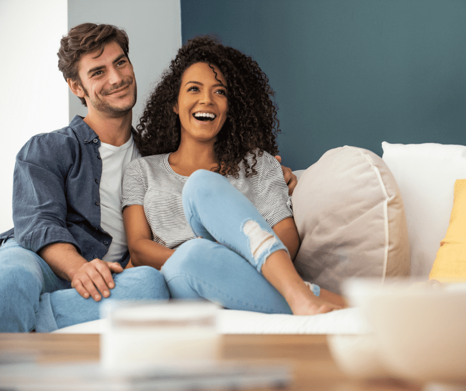 A happy couple sitting on a sofa