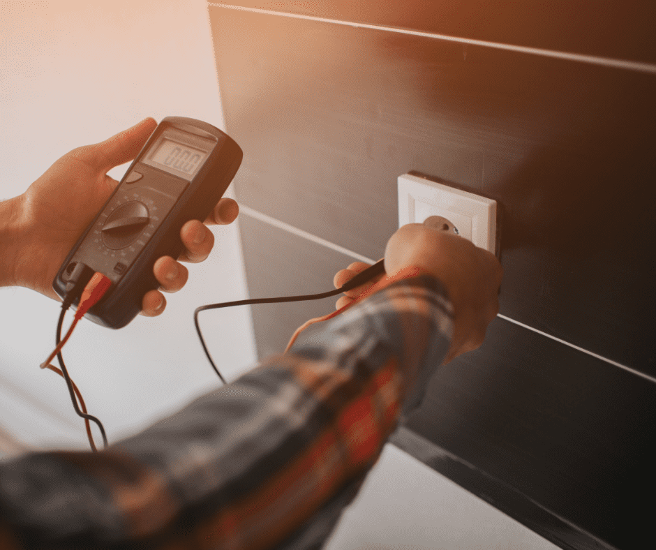 A man using a multimeter to check the voltage of an electrical outlet