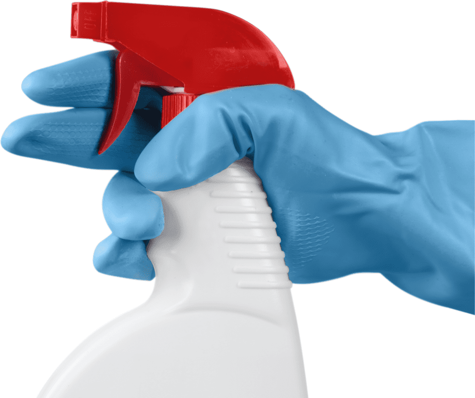 A hand with a glove holding a spray bottle