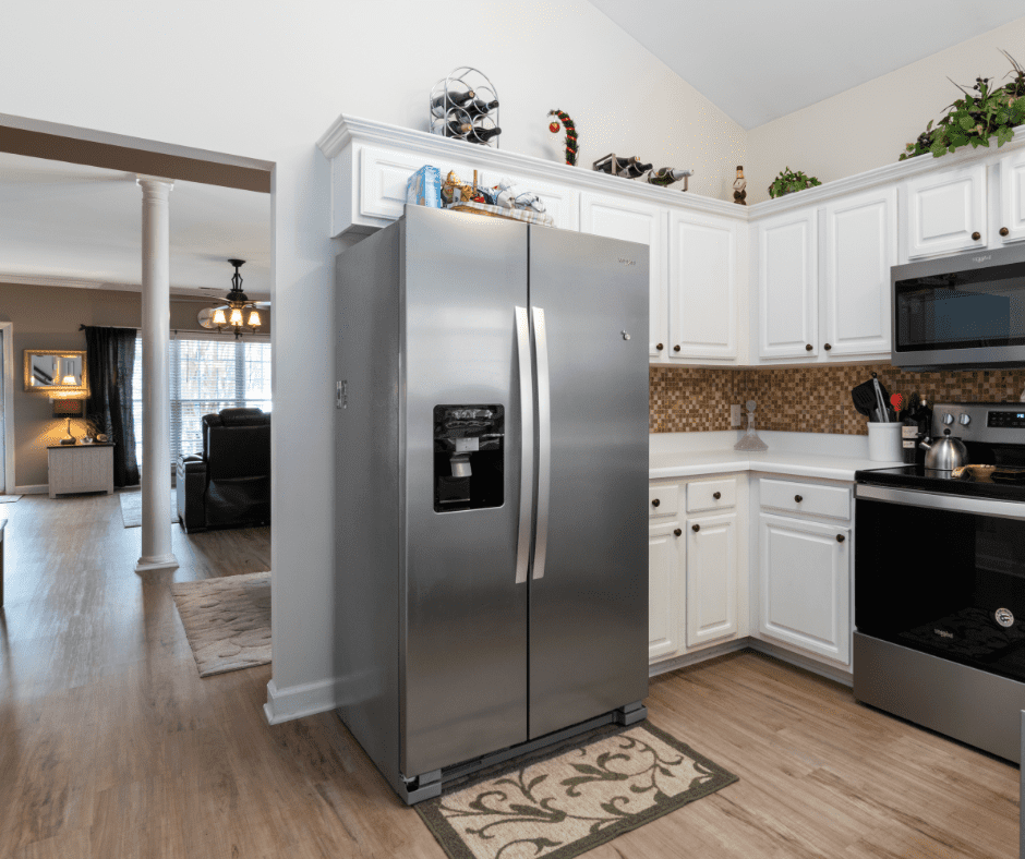 A very nice kitchen with a sleek looking refrigerator