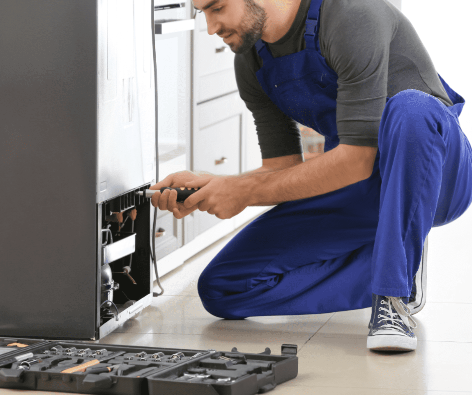 A technician fixing a refrigerator