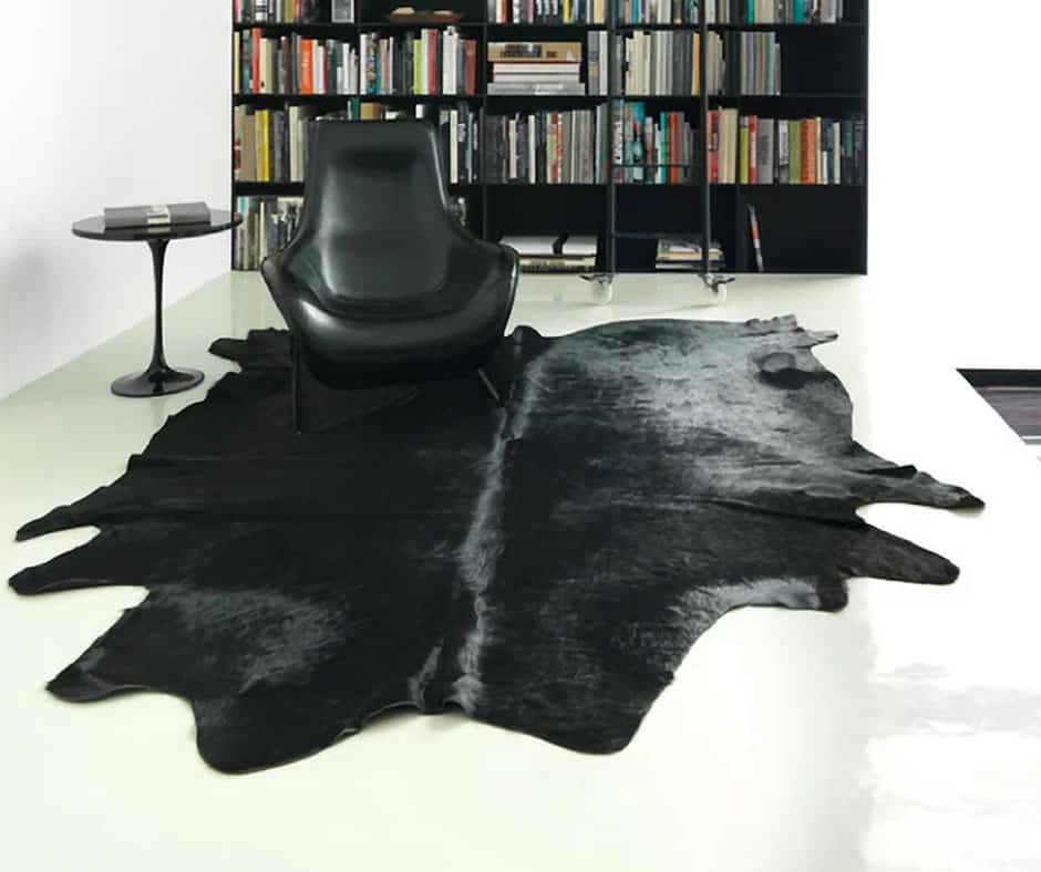 Living room with a solid black cowhide rug